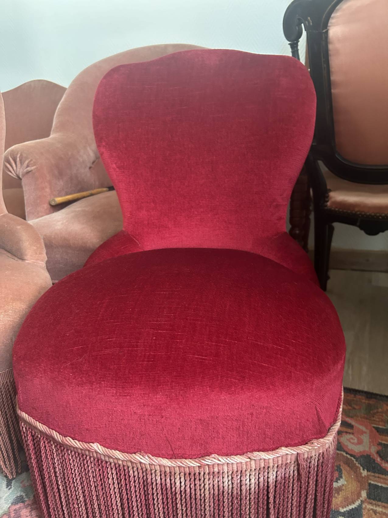 Vintage burgundy velvet armchair with fringes – theatrical and elegant