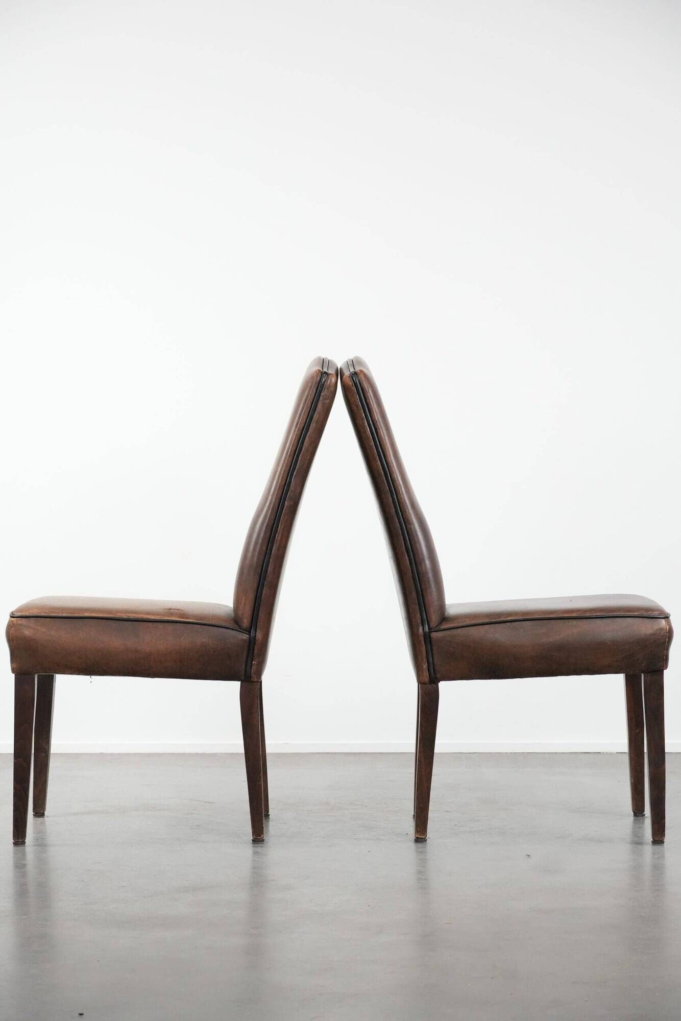 Set of 6 vintage sheepskin dining chairs finished with black piping