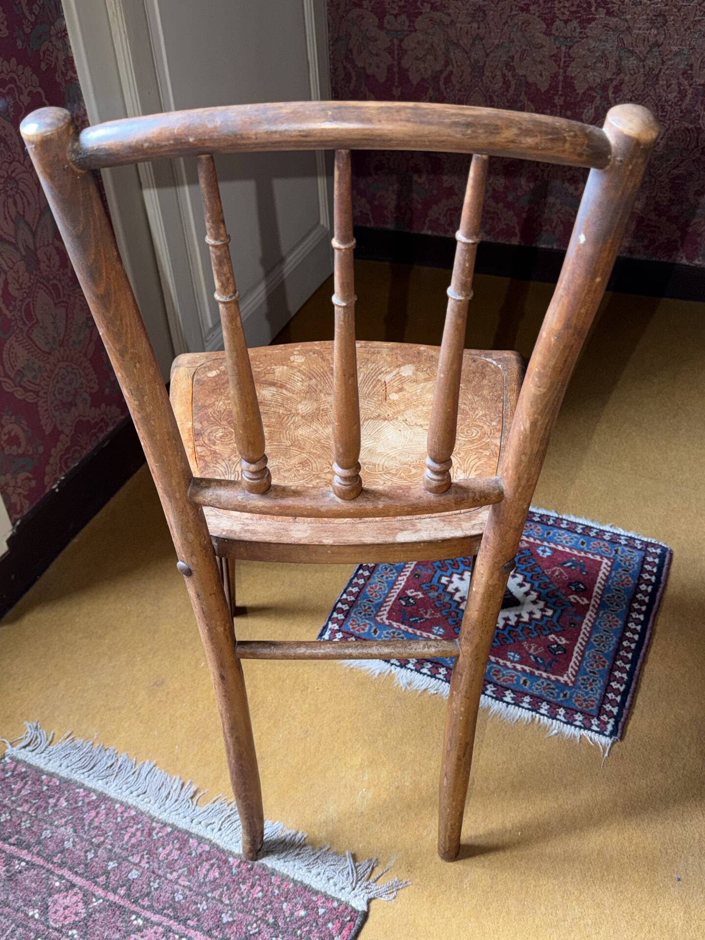 Old wooden bistro chair – decorated seat – rustic furniture