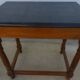 Nightstand or side table in solid wood with a black top.