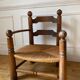 Straw and turned wood fireplace armchair in the style of Charles Dudouyt