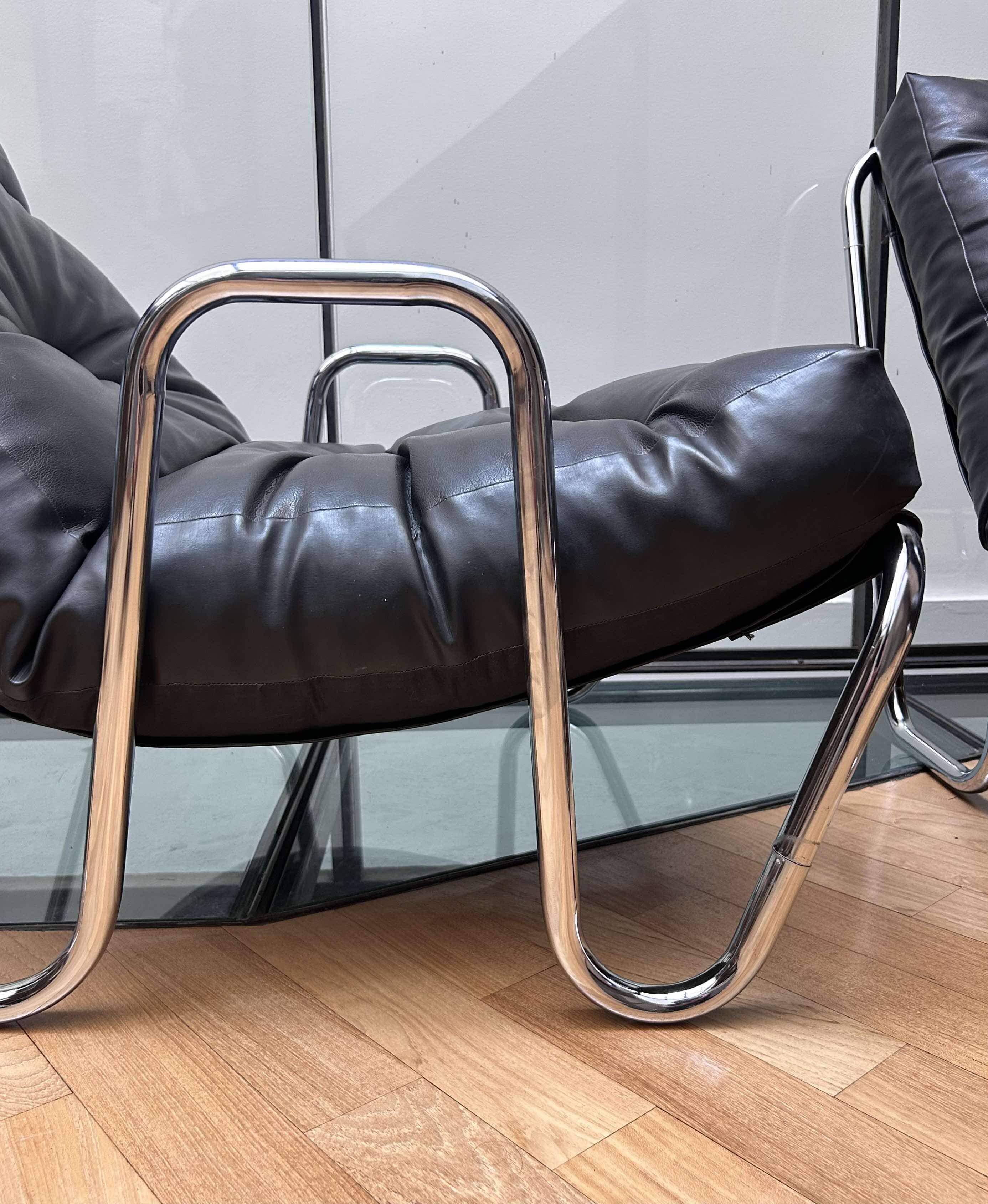 Pair of vintage armchairs in black imitation leather and chrome metal, France 1970