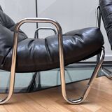 Pair of vintage armchairs in black imitation leather and chrome metal, France 1970