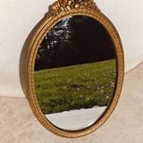 Authentic chic vintage oval mirror, in gilded wood, in baroque style.