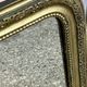 Louis Philippe mirror in gilded wood with an openwork frieze.