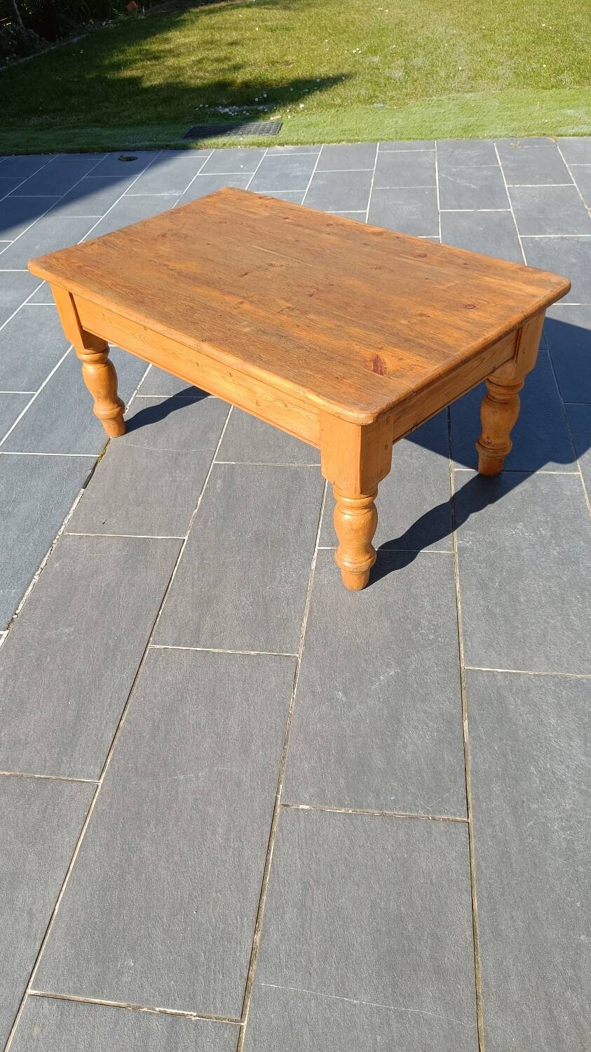 Solid oak coffee table with turned legs.