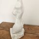 Sculpture of a female torso in white marble.