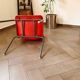 Pair of red plastic chairs with metal frame