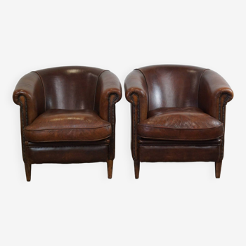 Set of two rugged sheep let of two rugged sheep leather club armchairs with a nice distressed look