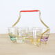 Set of 6 coloured and iridescent liquor glasses in their brass basket
