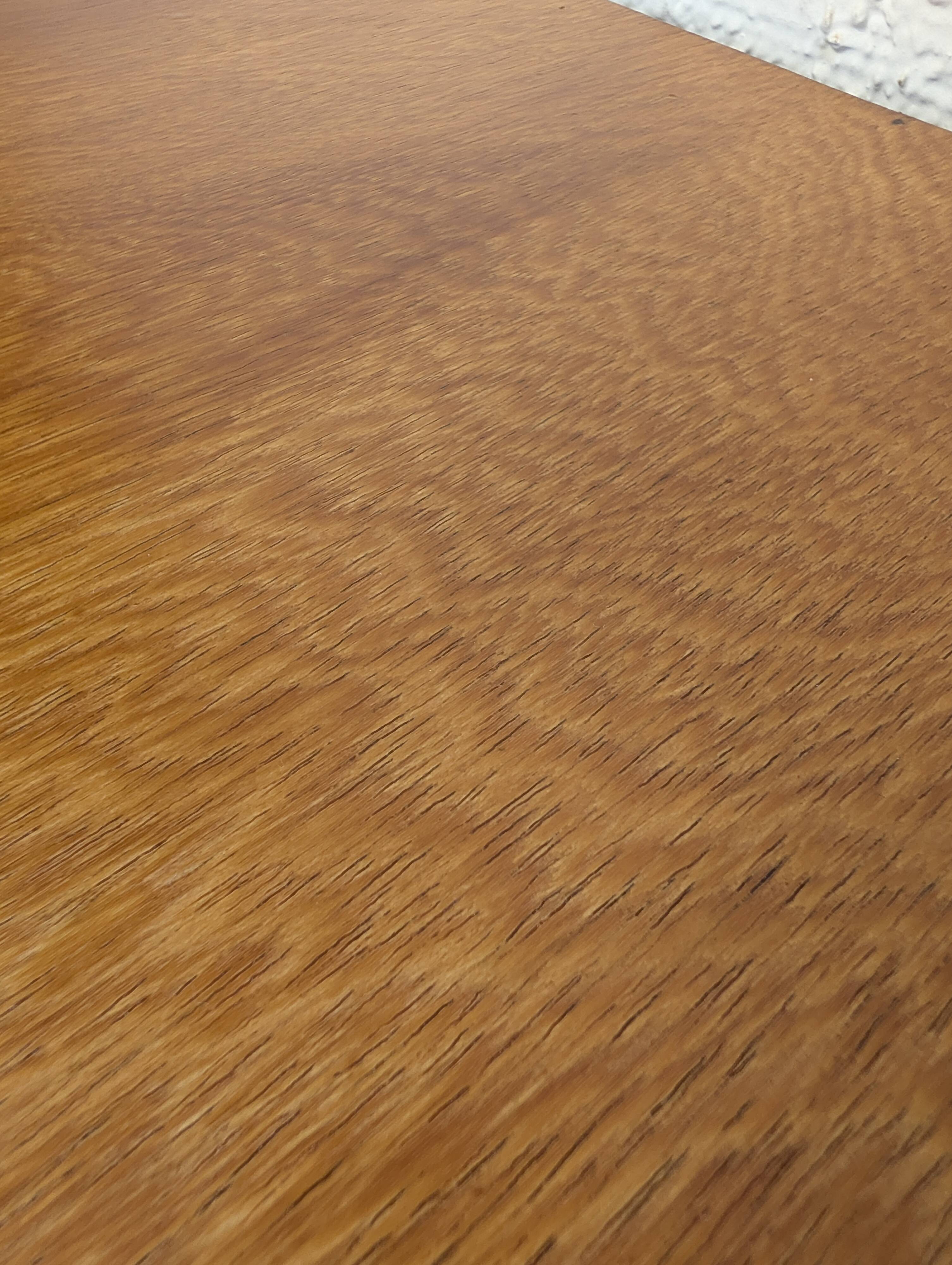 Vintage bedside table with tapered legs.