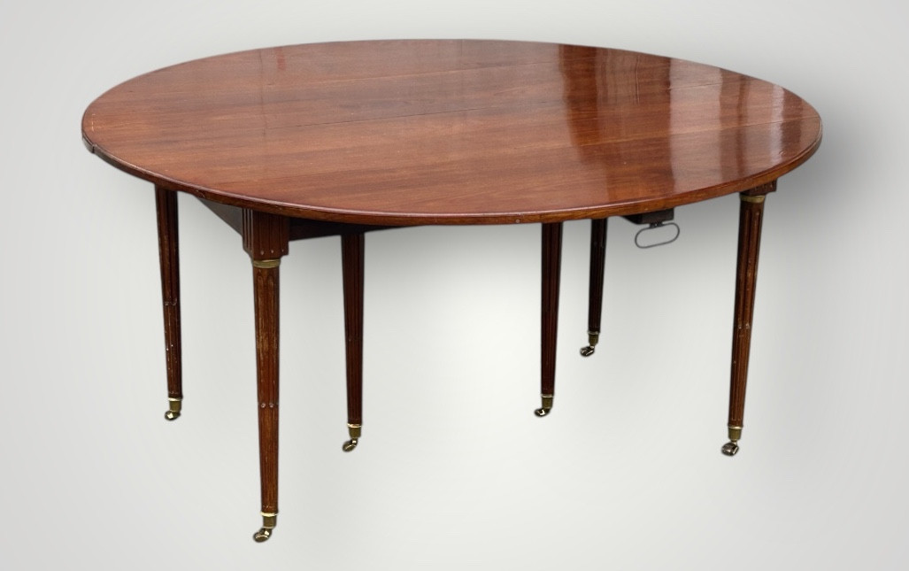 Solid mahogany dining table from the Louis XVI period, extendable.