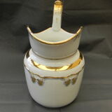 Milk jug or antique pitcher in white and gold porcelain.