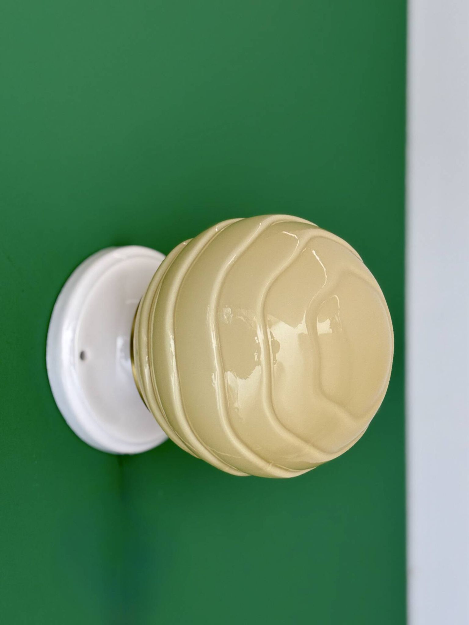 Vintage Art Deco globe wall light in pale yellow opaline.