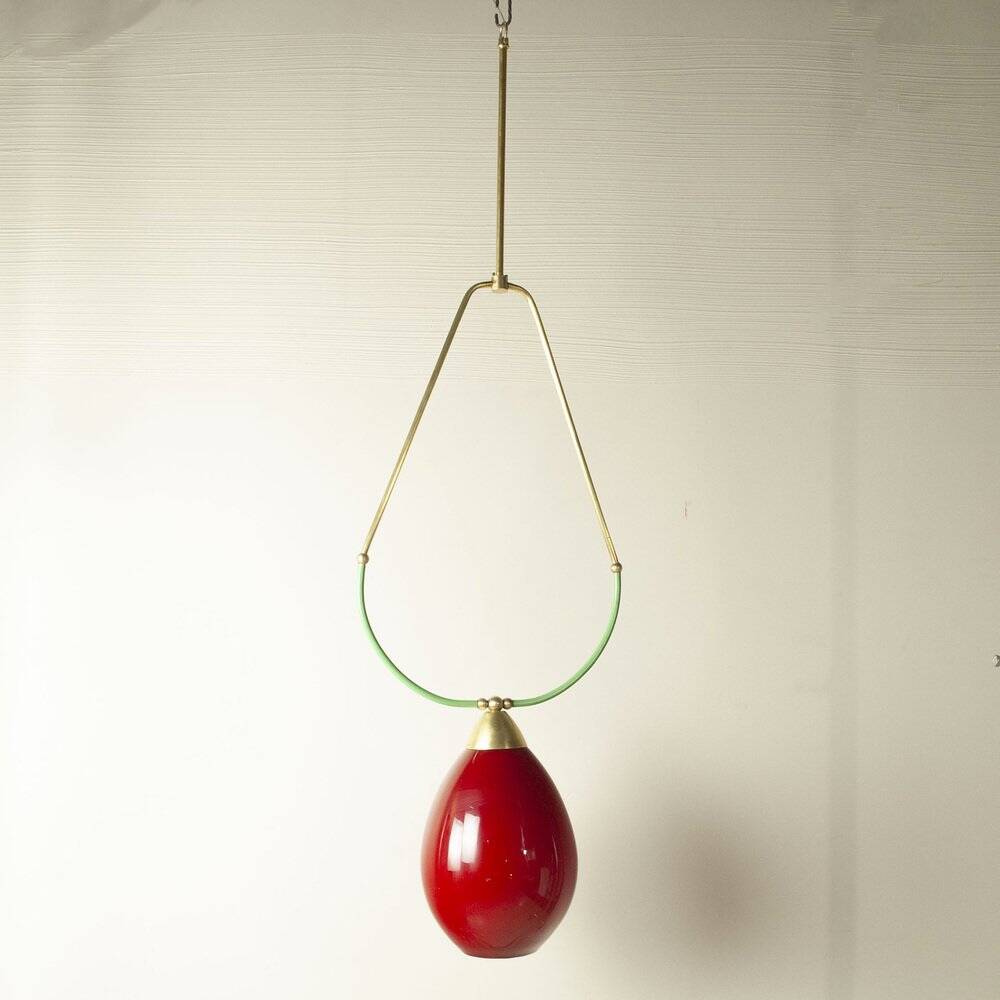 Hanging lamp with a brass frame in the shape of scales and a red-purple Murano glass diffuser.