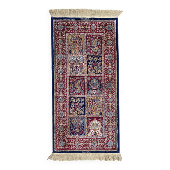 Vintage mechanical Turkish rug with box decoration on a red and navy blue background 139 x 68 cm