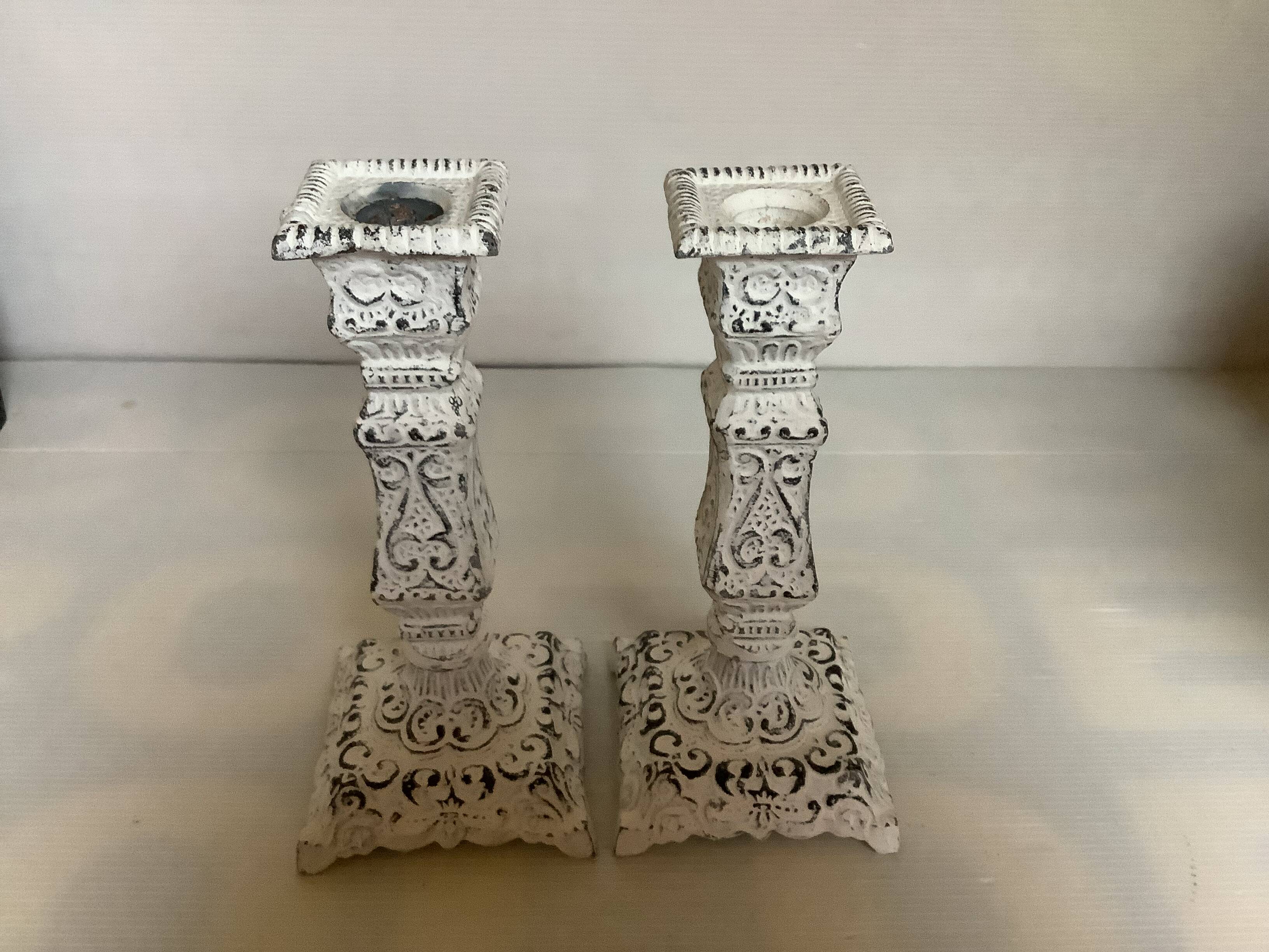 Pair of patinated cast iron candlesticks