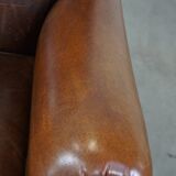 Sheep leather armchair on wheels