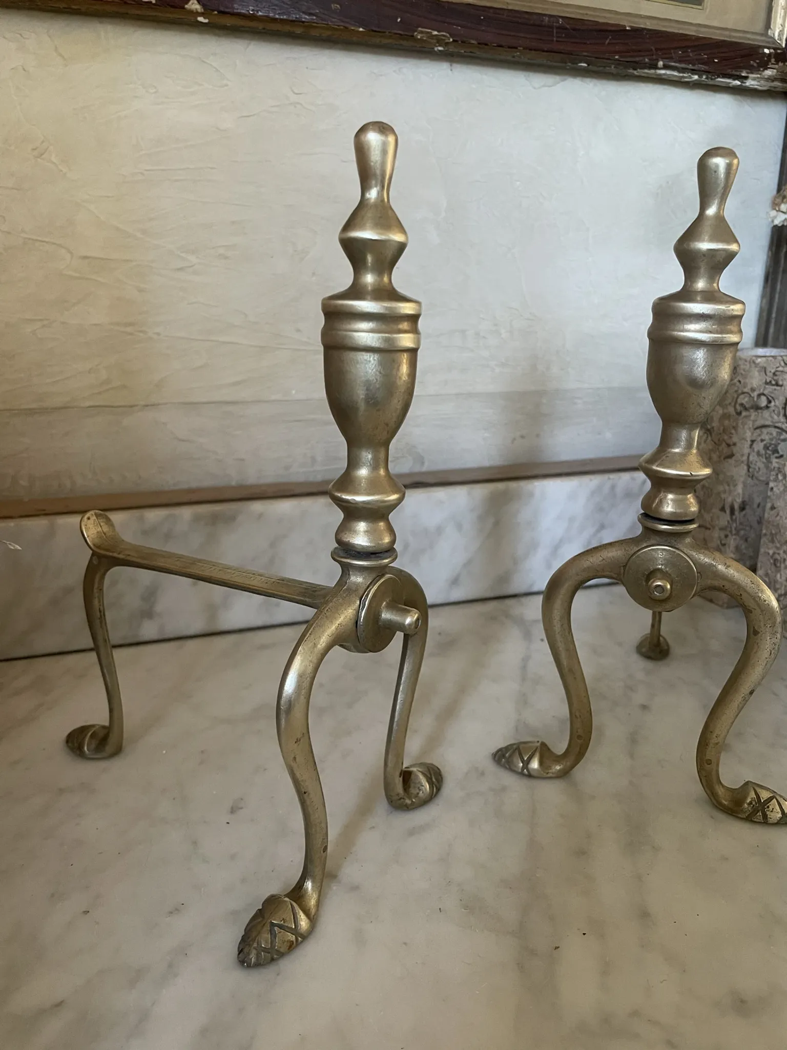 Pair of Victorian brass fire dogs from the late 19th century.