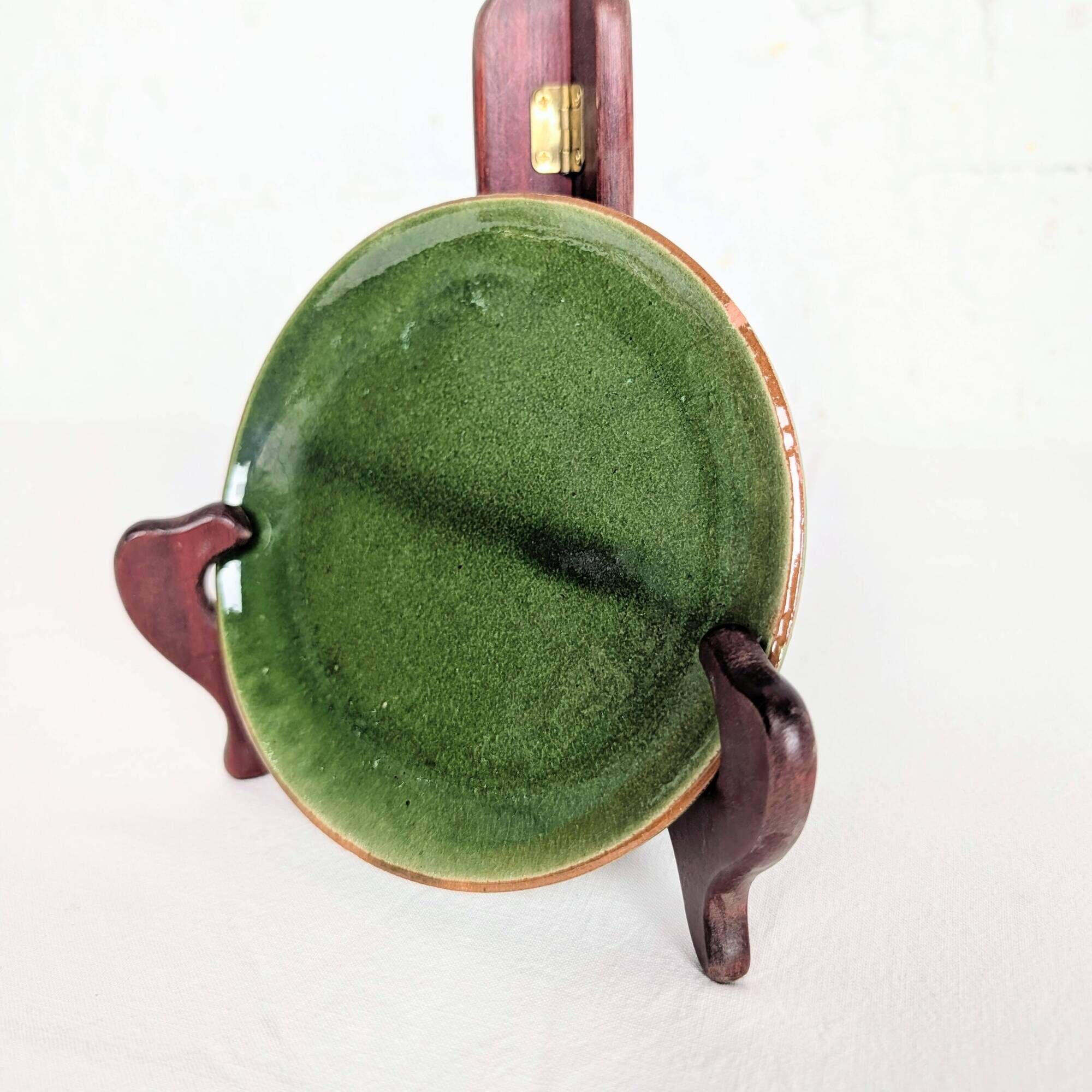 Small plate in glazed green earthenware