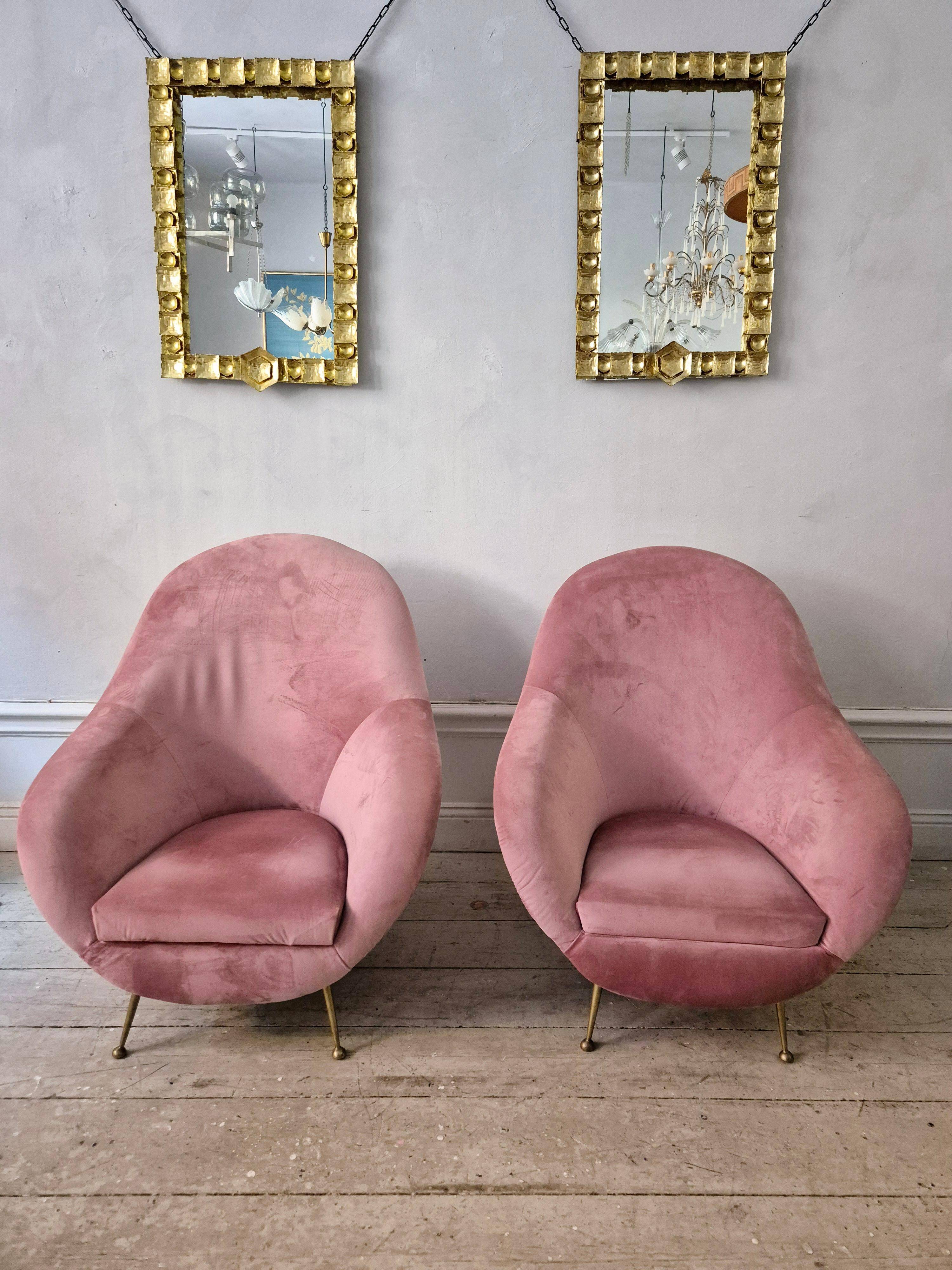 An elegant pair of armchairs with brass legs, Italy from the mid-20th century.