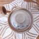 Old large vintage stoneware olive pot with its wooden spoon