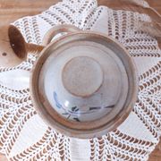 Old large vintage stoneware olive pot with its wooden spoon