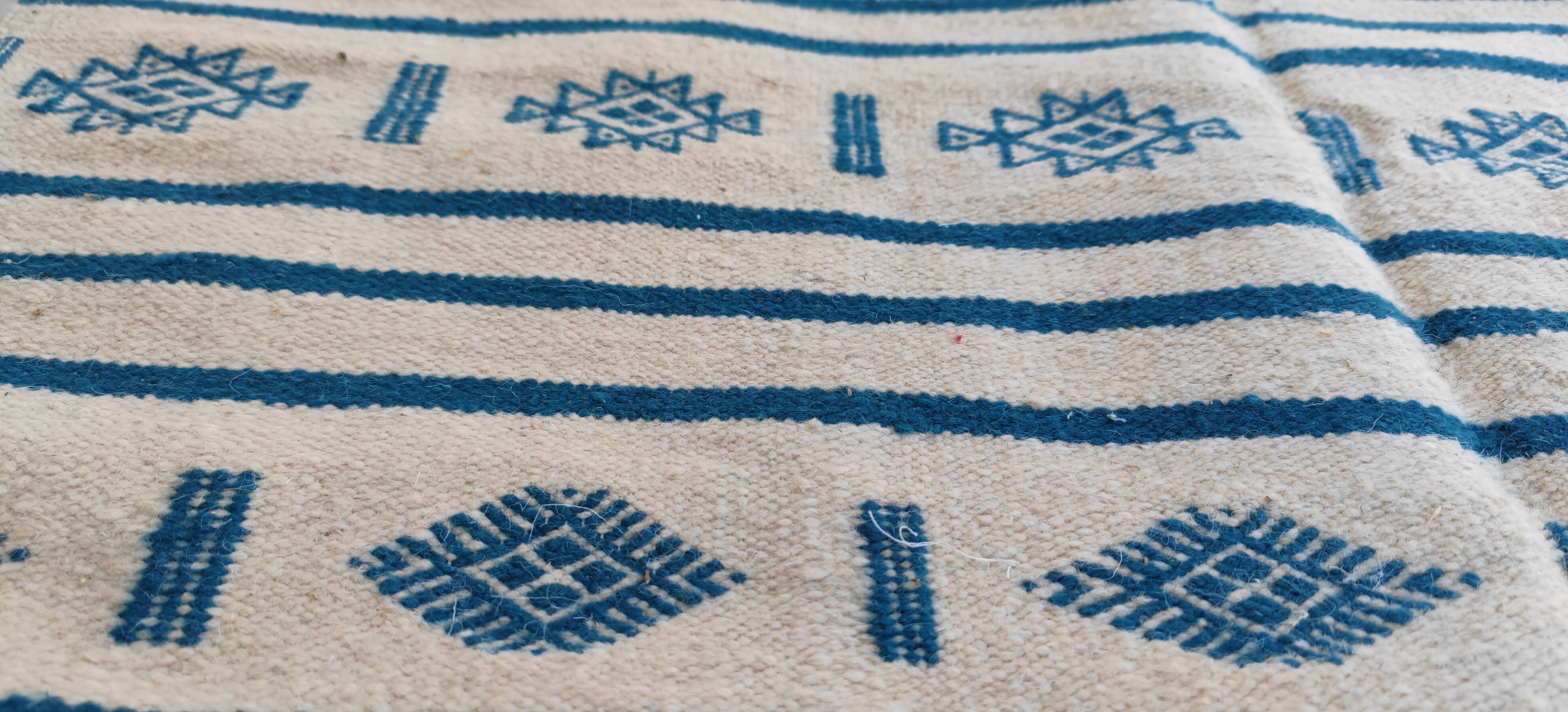 Traditional handmade white and blue kilim rug in natural wool