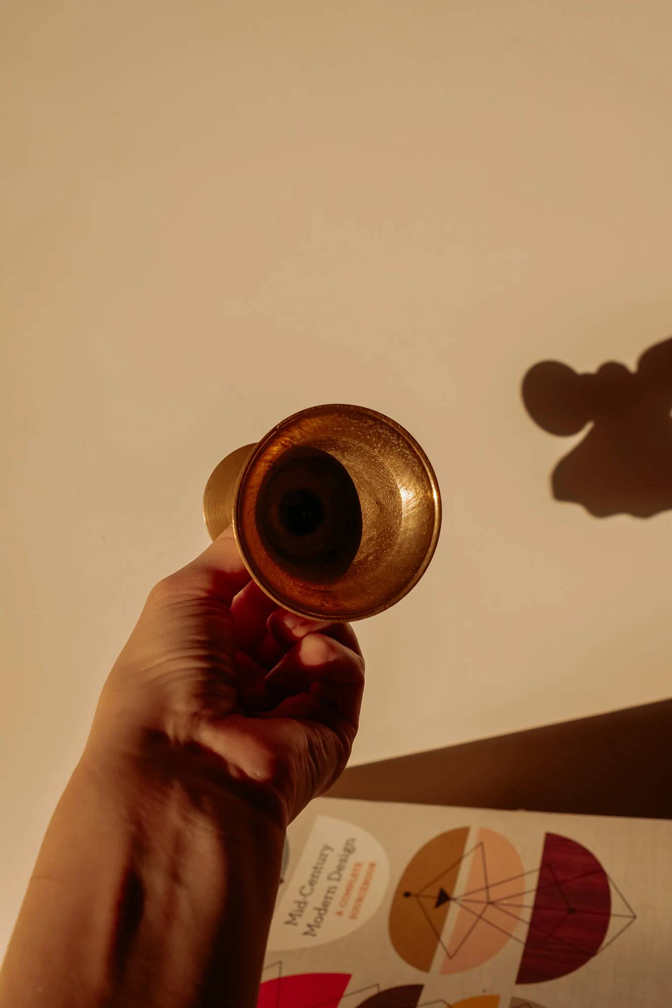 Brass candlestick in the shape of a bell.