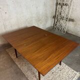 Extendable teak and teak veneer dining table
