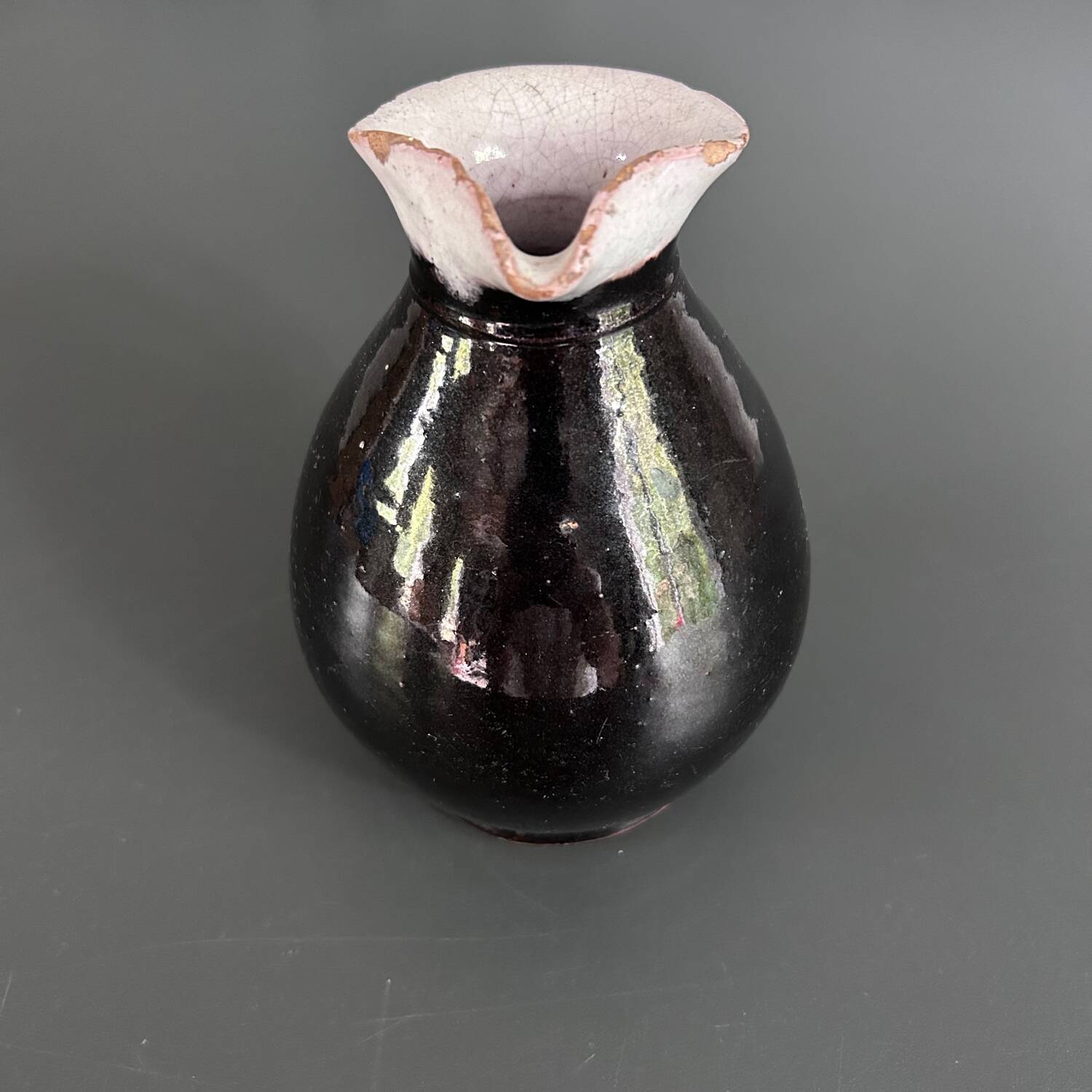 Antique black pitcher with white collar