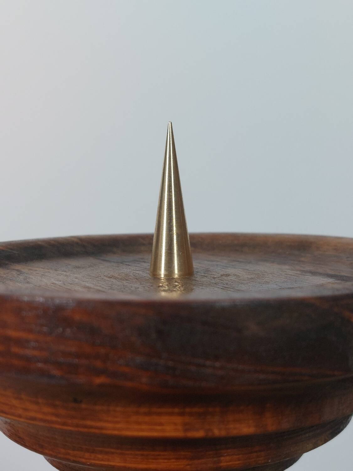 Vintage candle holder in an organic shape with a brass spike and tiered top.