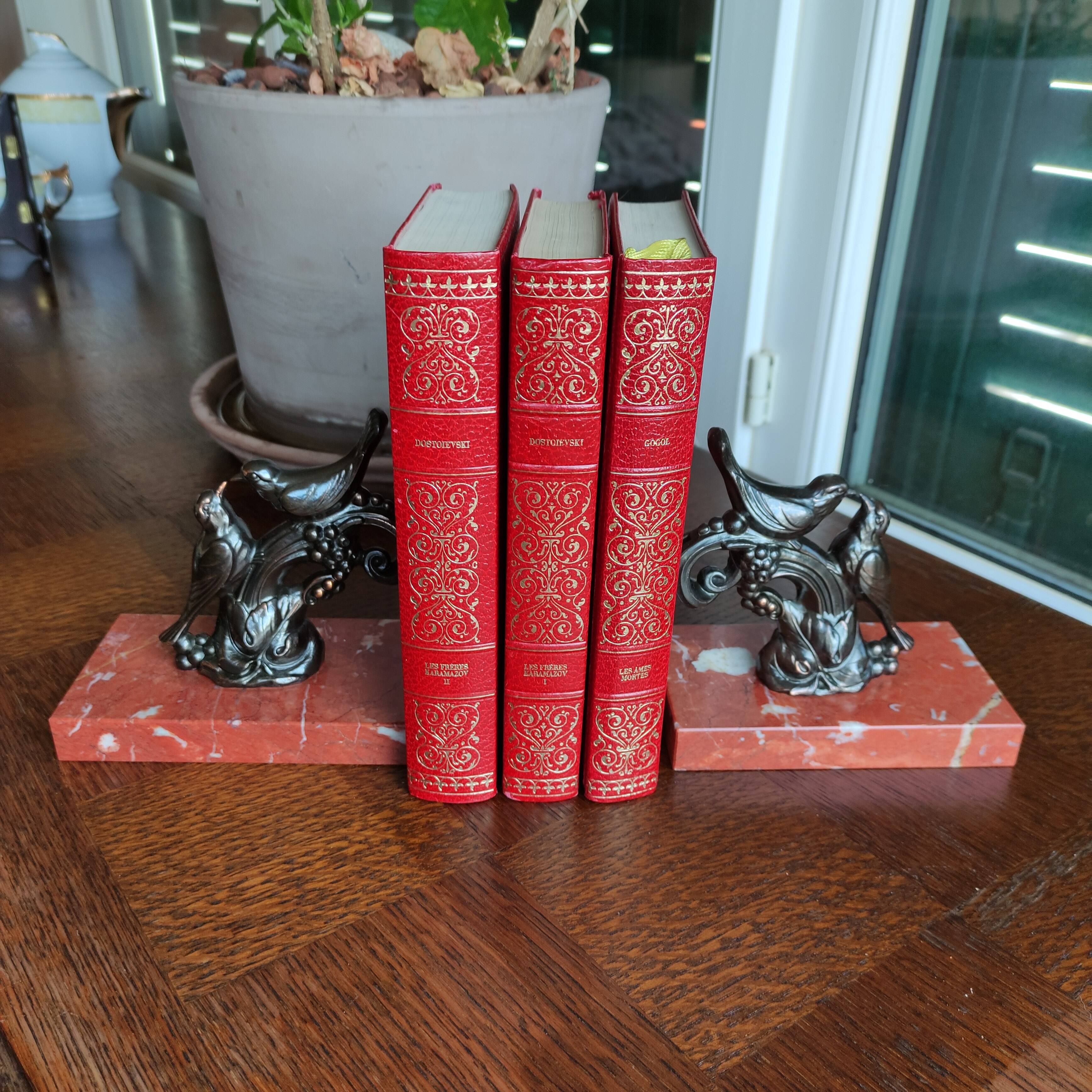 Zinc art bookends in the shape of birds on red marble - warblers