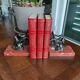 Zinc art bookends in the shape of birds on red marble - warblers