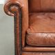 Sheepskin armchair with comfortable seat and finished with decorative nails