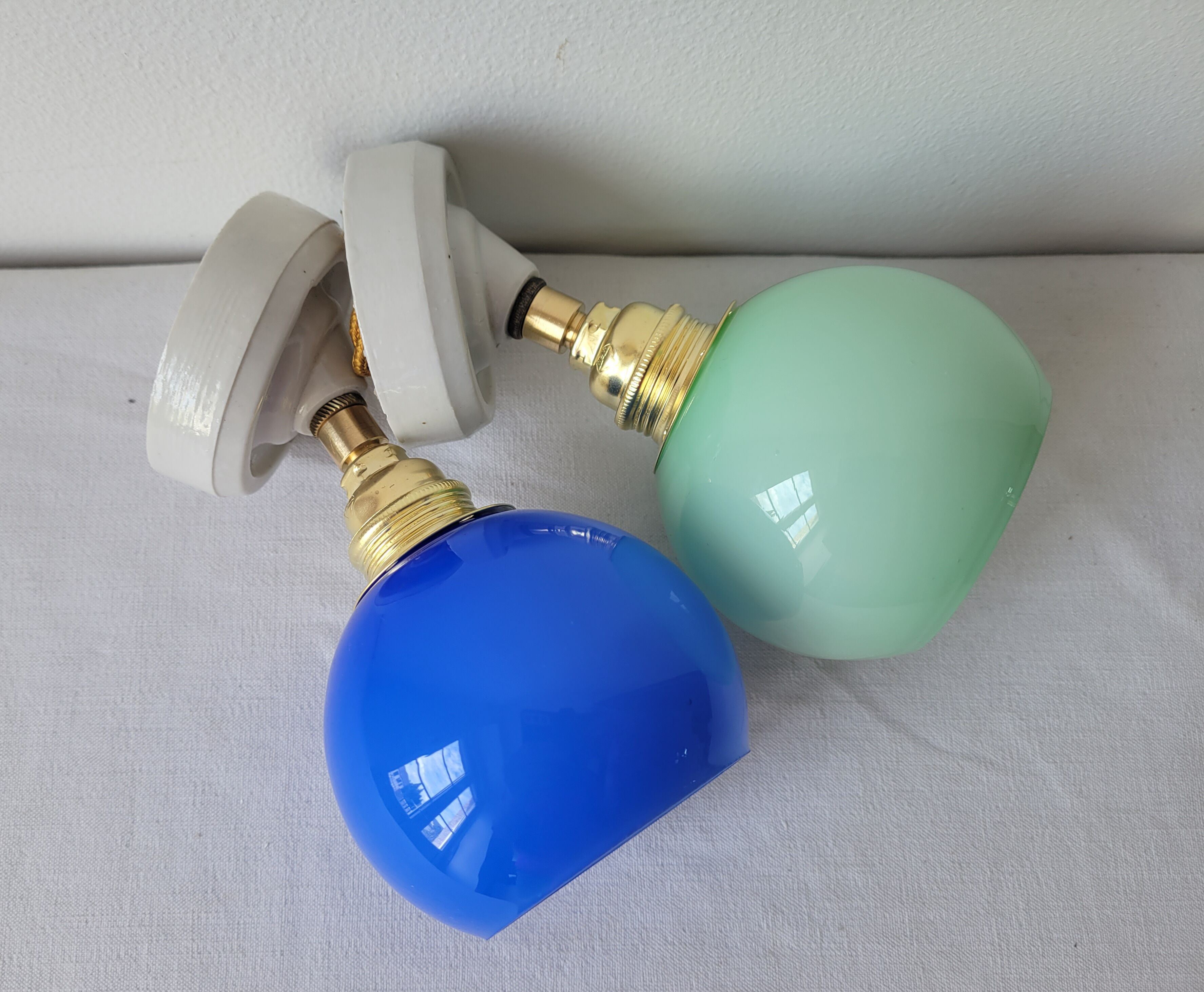 Duo of porcelain and opaline wall lamps