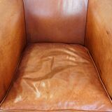 Cognac-colored cow leather club chair finished with decorative nails in English style