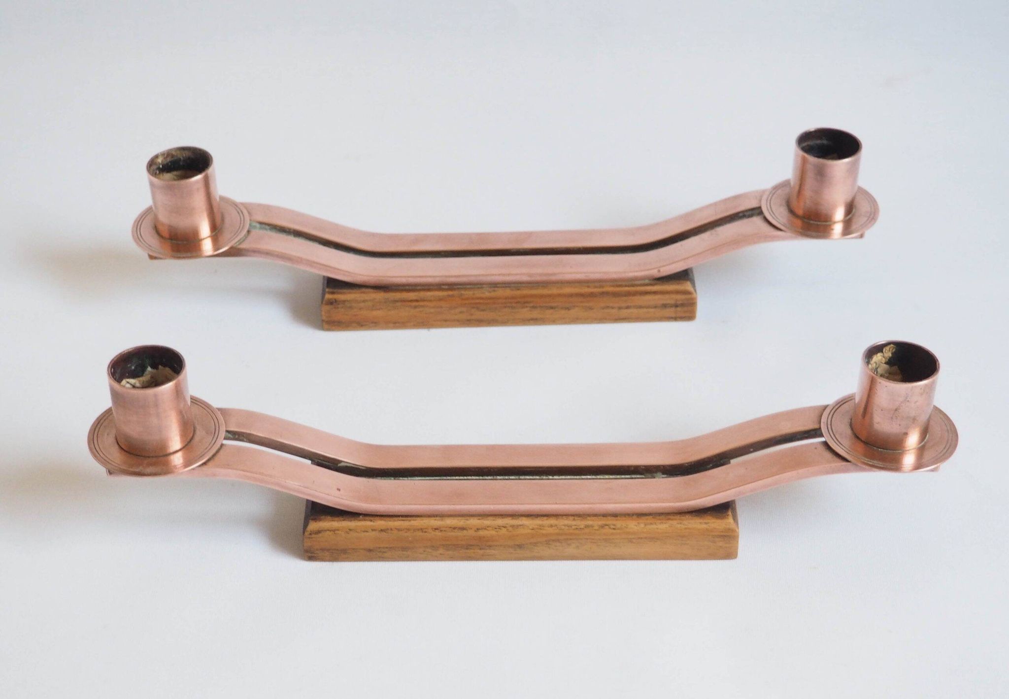 Pair of oak and copper bronze candlesticks