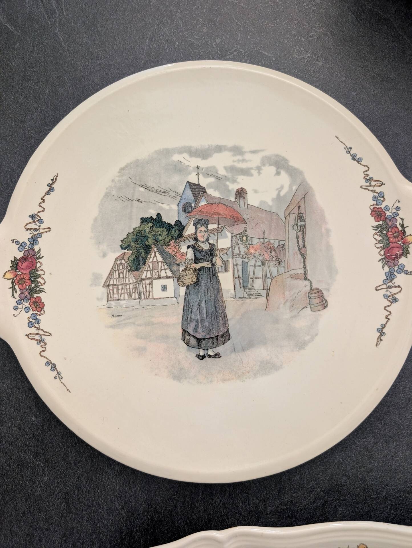 Two earthenware dishes from Obernai signed Henri Loux.