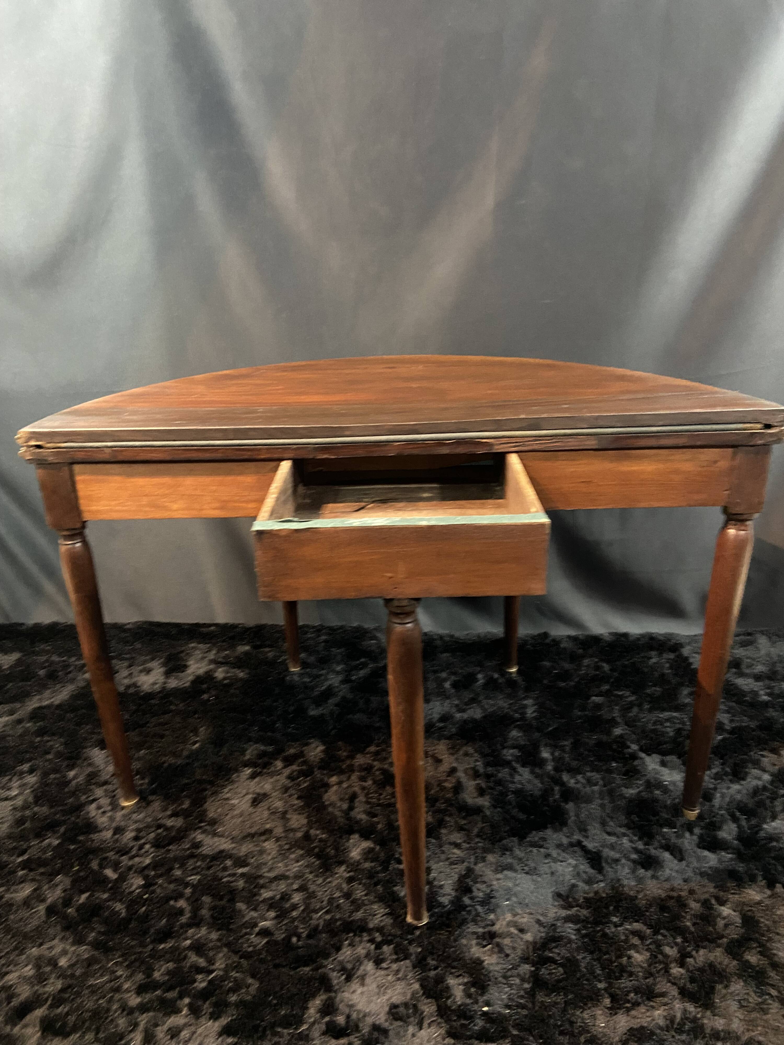 A Louis XVI period mahogany half-moon table forming a console/games table