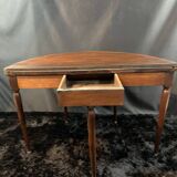 A Louis XVI period mahogany half-moon table forming a console/games table