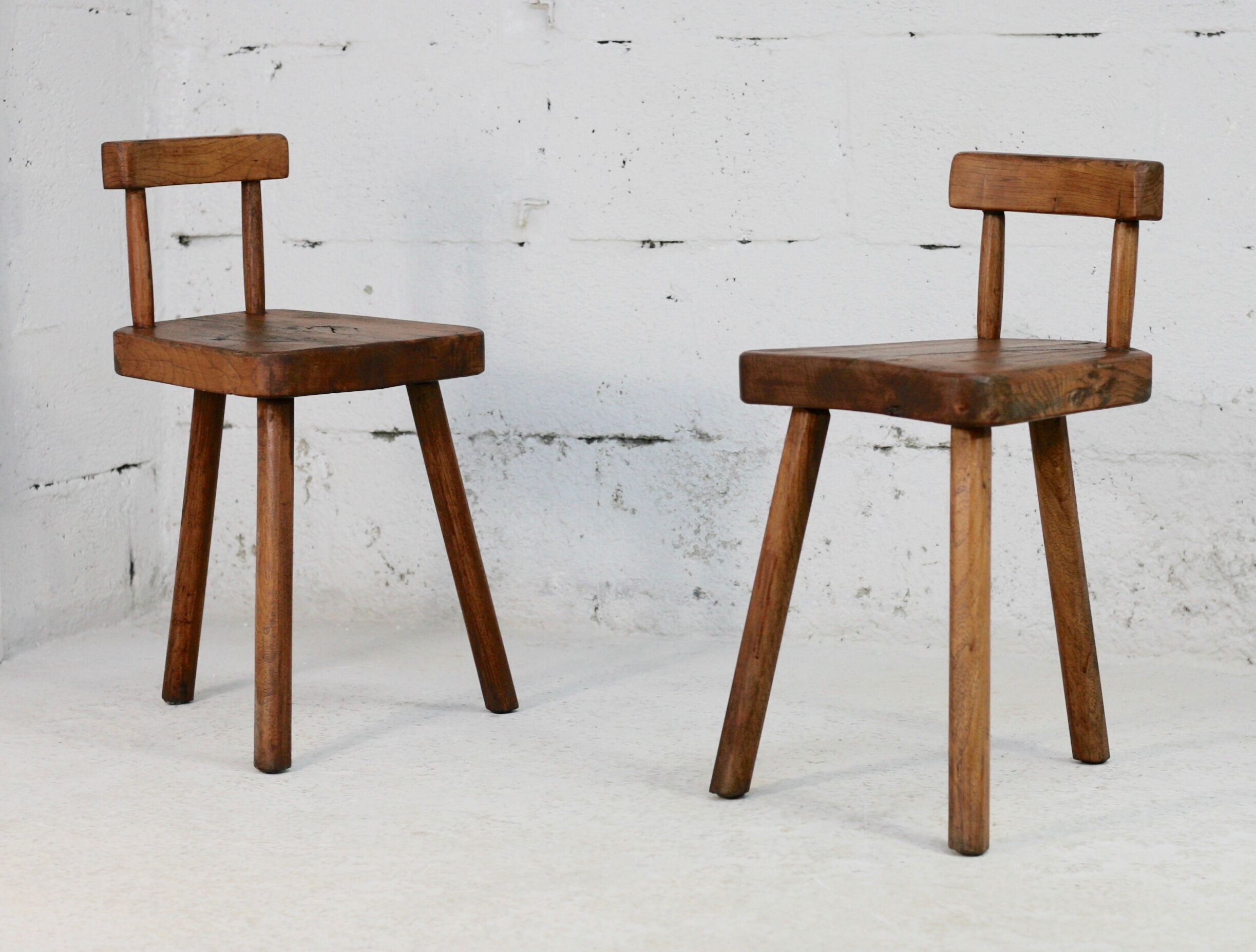 Pair of tripod stools with brutalist backrests, France, circa 1960