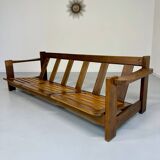 Old 3-seater sofa in solid wood, Maison Regain design, from the 70s.