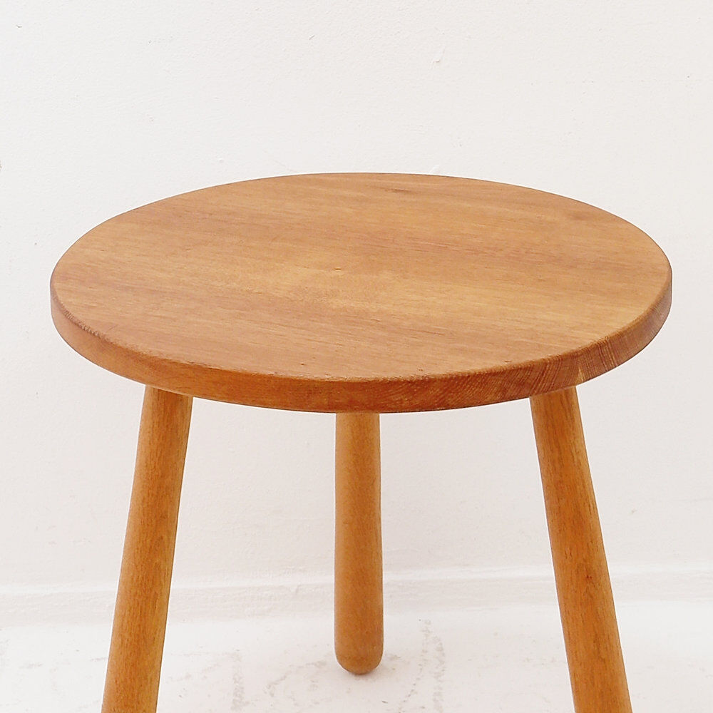 Vintage solid wood side table with rounded legs.