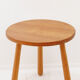 Vintage solid wood side table with rounded legs.