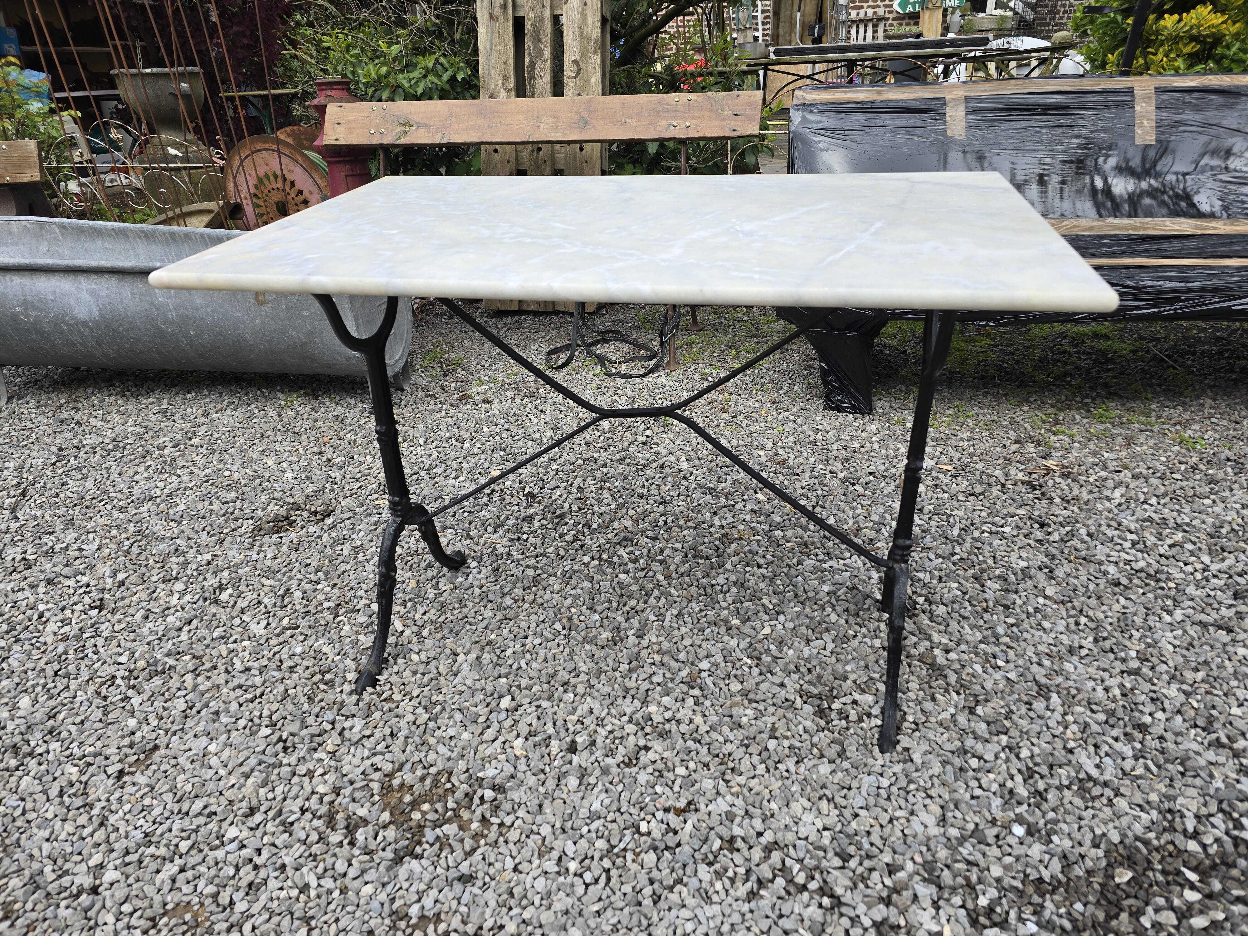 Bistro table with marble top and cast iron base
