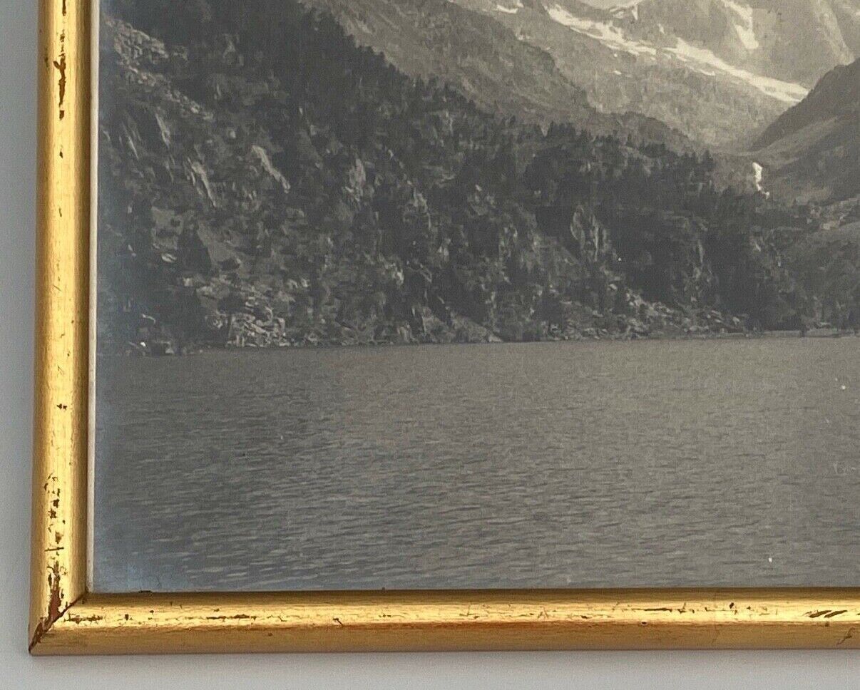Photo in black and white mountain lake in golden frame