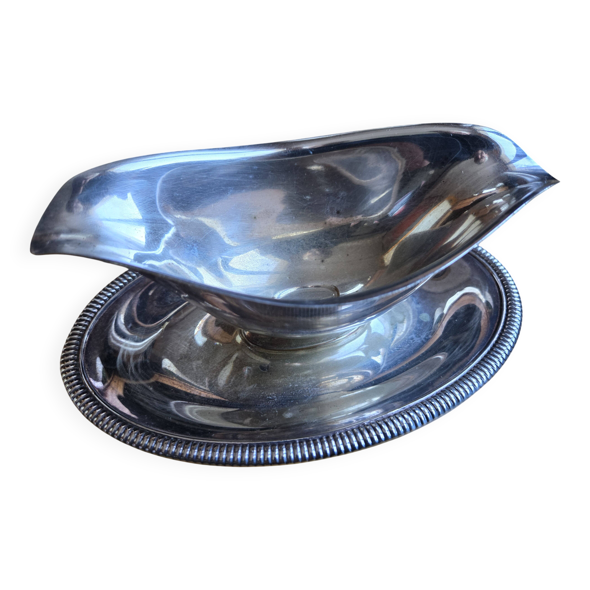 Silver-plated metal gravy boat on a stand