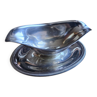 Silver-plated metal gravy boat on a stand