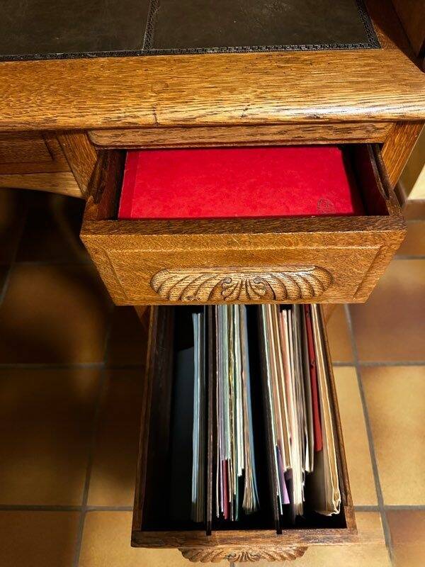 Oak desk with sliding door and leather wood chair.